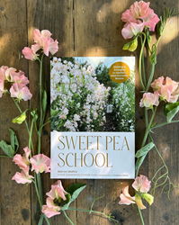 The book Sweet Pea School surrounded by flowers. 